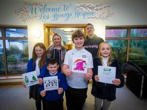 Left to right, Peyton Fletcher, Jacob Ceillam, Louie Bell and Aoife-Marie Manning holding their winning Christmas card designs in a competition to support Les Bourgs Hospice. Behind are Kayley Girard and Mark Brook, from the charity committee at Moonpig, which came up with the idea. (Picture by Peter Frankland, 31518665)