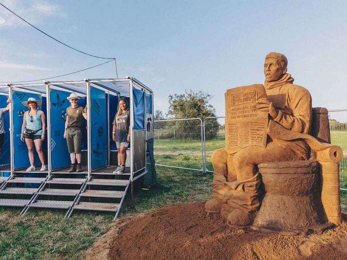 Huge mud toilet sculpture unveiled at Glastonbury to warn against climate change