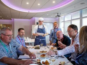 Seated, left to right: Judges Chris Torode (Guernsey Institute, director of apprenticeships), Stephen Hare (Sovereign Trust Guernsey), David Matheson (owner of Red restaurant), Pierre Blampied (managing director of SPF Private Clients) and Amanda Eulenkamp (Guernsey Press). Standing: Will Martin, left, explaining the menu, and judge Gary Wallbridge. (Picture by Luke Le Prevost, 30882905)