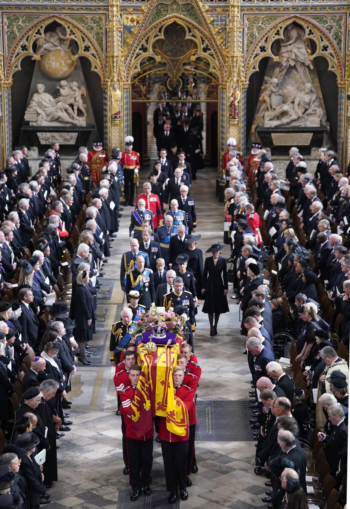 King Charles III, the Queen Consort, the Princess Royal, Vice Admiral Sir Tim Laurence, the Duke of York, the Earl of Wessex, the Countess of Wessex, the Prince of Wales, the Princess of Wales, Prince George, Princess Charlotte, the Duke of Sussex, the Duchess of Sussex, Peter Phillips and the Earl of Snowdon follow behind the coffin of Queen Elizabeth II, draped in the Royal Standard with the Imperial State Crown and the Sovereign's orb and sceptre, as it is carried out of Westminster Abbey after her State Funeral. Picture date: Monday September 19, 2022. (31281910)