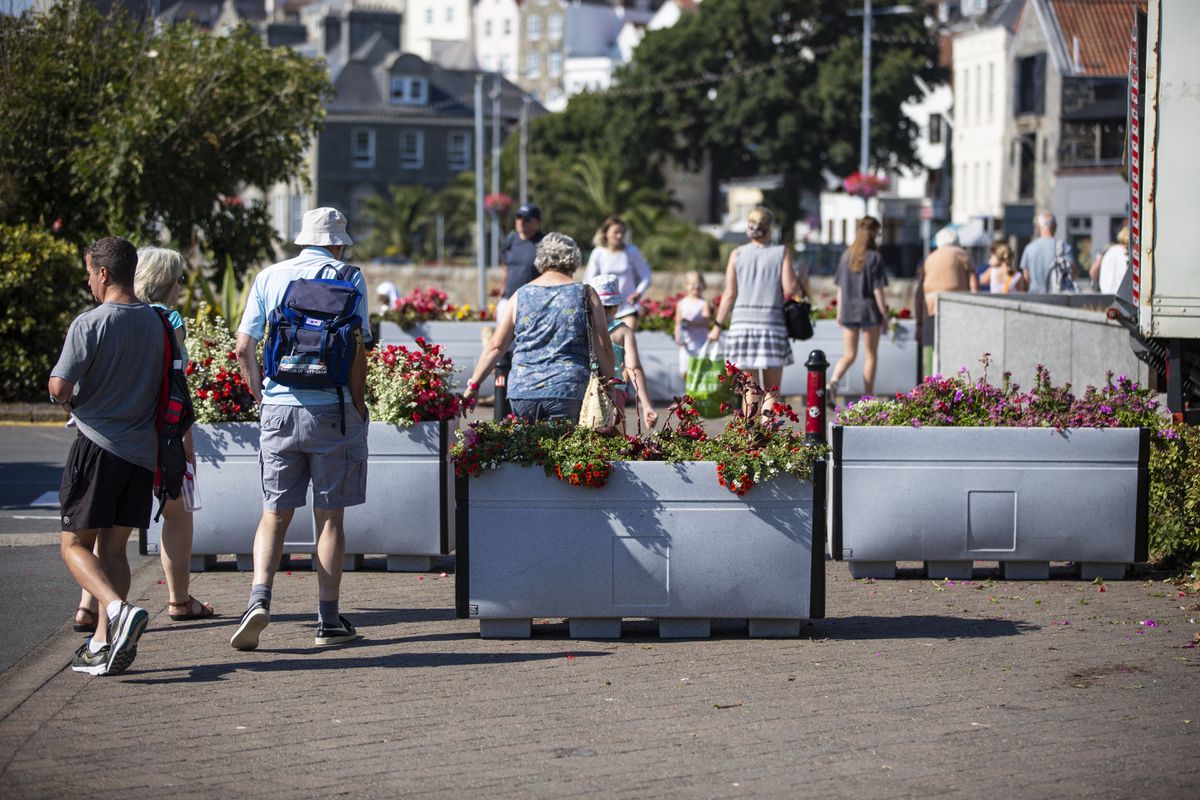 The planters at the crossing between North Beach car park and the Liberation monument have been moved further apart to allow people with accessibility issues to get through. The planters have been placed there to stop cyclists using the crossing and to get people to look before crossing the road. (31146003)