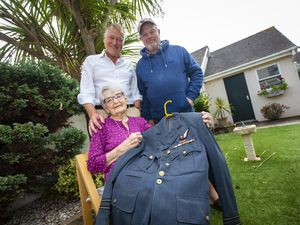 Marion Delbridge with her two sons John, left, and Jim, and her late husband’s uniform. Ken was a navigator on Wellington and Lancaster bombers during the Second World War and would have been 100 years old today. (Picture by Peter Frankland, 31242102)