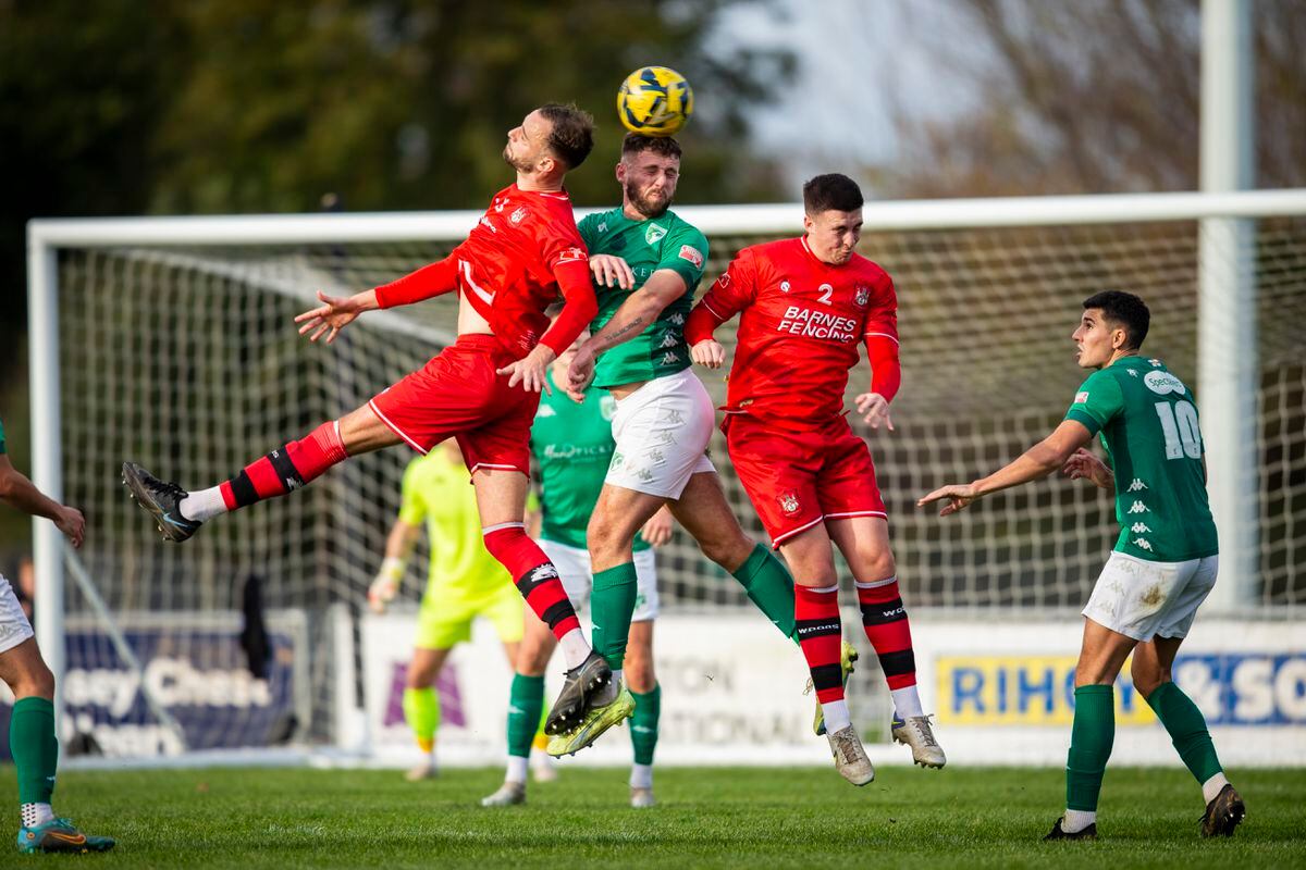 Guernsey FC goal-scorer Sam Murray rises to win a header between two Northwood opponents on Saturday at Footes Lane. (Picture by Luke Le Prevost, 31490635)