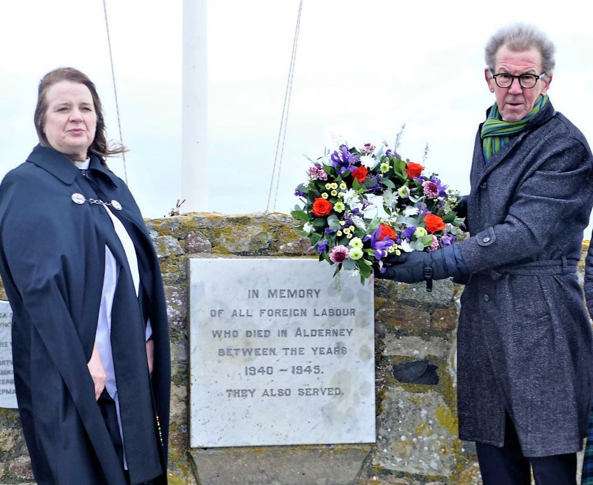 The vicar of Alderney, the Rev. Jan Fowler, and States President William Tate with the wreath laid at the dedication plaque to all the slave workers who died between 1940 and 1945. Picture by David Nash (30436765)