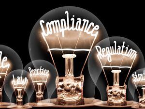 Photo of light bulbs with shining fibers in a shape of COMPLIANCE concept related words isolated on black background (30860936)