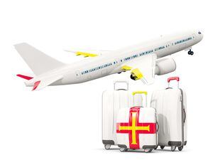 Luggage with flag of guernsey. Three bags with airplane isolated on white. 3D illustration (31480111)