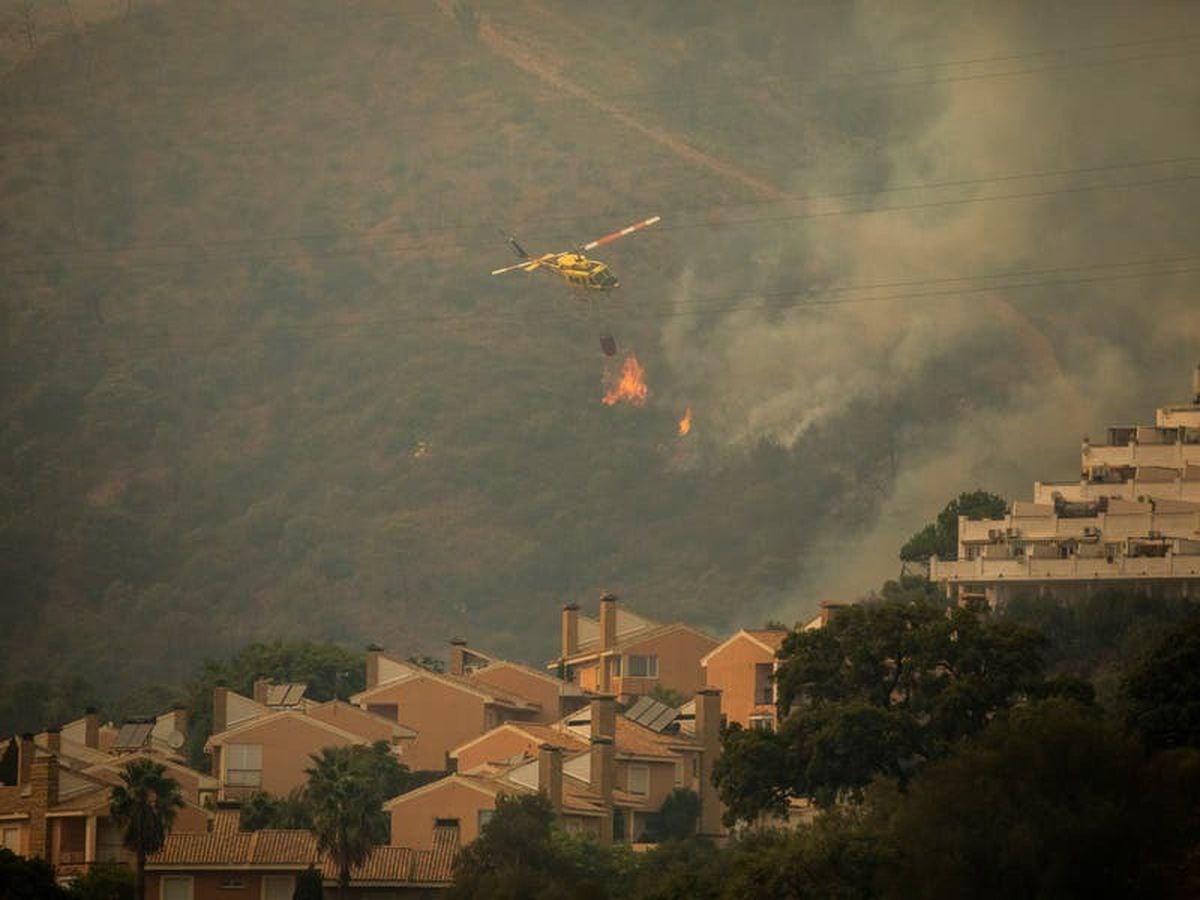 Wildfire in Spain kills firefighter, forces evacuations and shuts ...