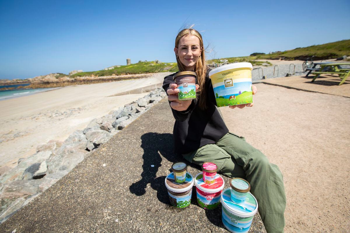 Guernsey Dairy has unveiled new packaging for its ice-cream this summer. Izzy Millis from L’Ancresse Kiosk holding the vanilla tub, which has L'Ancresse tower, behind her, included in the design of its tub. (Picture by Luke Le Prevost, 32152860)