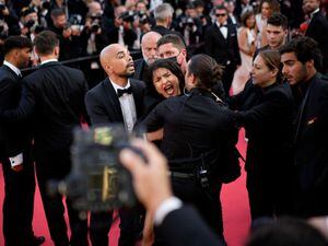 Woman strips off in Cannes red carpet protest
