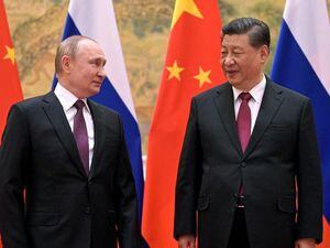 Chinese President Xi Jinping, right, and Russian President Vladimir Putin talk to each other during their meeting in Beijing on February 4 2022 (30587670)