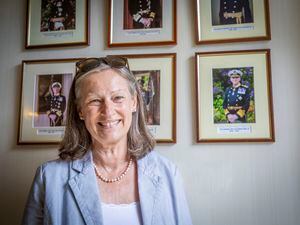 Tina Pipet, who has been made a Member of the Royal Victoria Order, the personal gift of the Queen, in recognition of her service at Government House. She is standing in front of the portraits of the four Lt-Governors she served as personal assistant. (Picture by Sophie Rabey, 30884694)