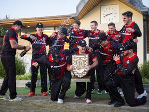 Captain Nathan Le Tissier holds the Rozel Shield while Will Peatfield sprays his Indies teammates with champagne last night at the KGV as they became Evening League champions for the first time. (Picture by Luke Le Prevost, 31053113)