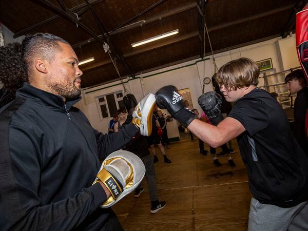 Picture by Sophie Rabey.  04-11-22.   Professional British Heavyweight Boxer Joe Joyce is in Guernsey and visited the Amalgamated Boxing Club to meet local boxers.  Albie Netherton (aged 14). (31445228)