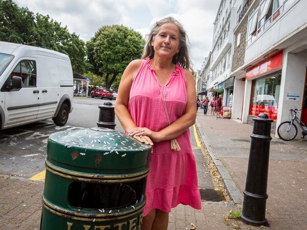Picture by Luke Le Prevost. 29-06-23..St Peter Port's constables are complaining that town has become unsightly due to rubbish, graffiti and lack of maintenance, before the Island Games commence. Senior constable Zoe Lihou next to vape stickers on a bin. (32255395)