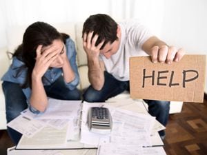 young couple worried need help in stress at home couch accounting debt bills bank papers expenses and payments feeling desperate in bad financial situation (31242547)