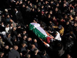 Palestinians bury dead as risk of flare-up ebbs after Israeli raid