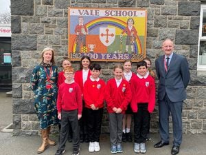 Head teacher Gary Hind and deputy head Lauren Eyton-Jones with some of the Vale Primary pupils whose school was marked as good in all five categories in the first Ofsted inspection tailored for Guernsey.