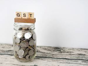 Government service tax or GST with a jar of coins. (30573575)