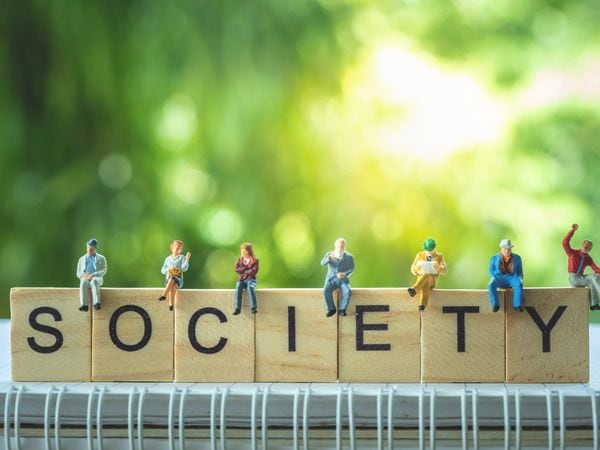 Miniature people, group of business people sitting on wooden blocks with SOCIETY word, doing activity and discussing ideas, society and teamwork concept. (31124613)