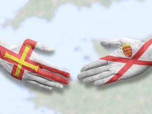 Jersey and Guernsey - Flag handshake symbolizing partnership and cooperation (32068244)