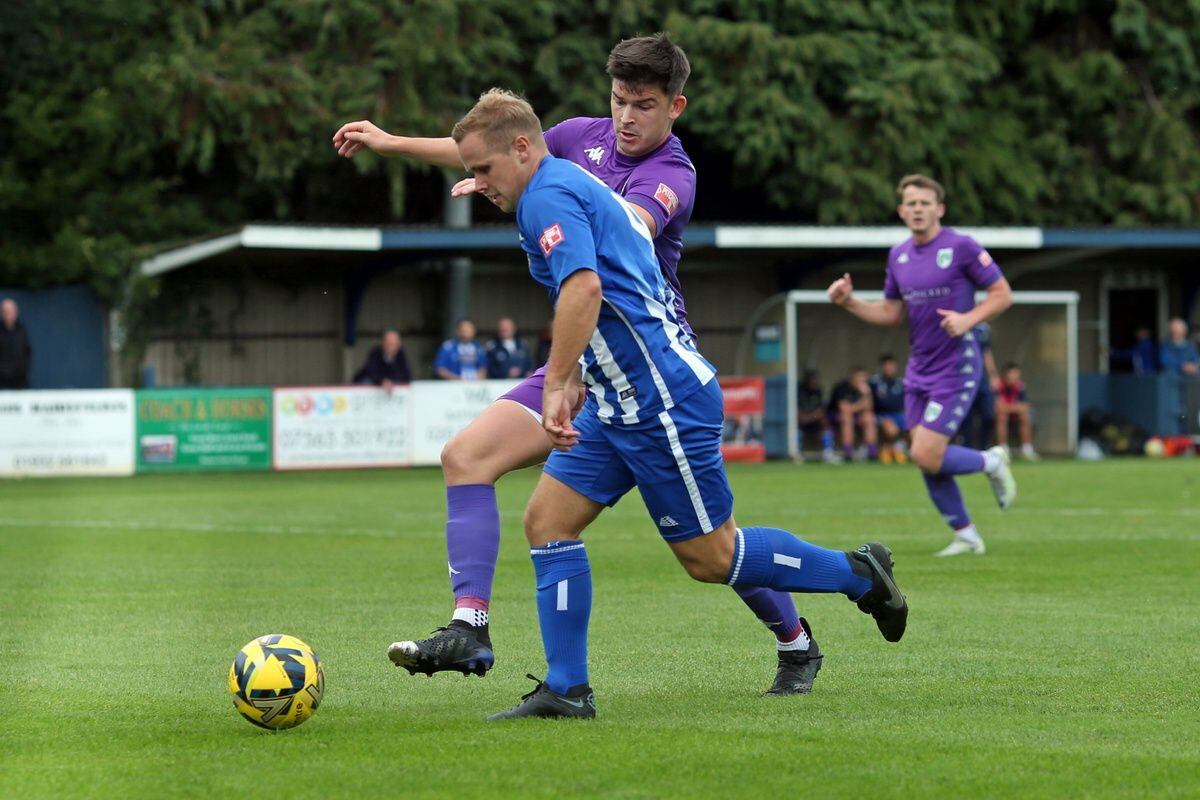 Jacob Fallaize tries to halt a Chertsey Town attack. (Picture by ESA Photos, 31327213)