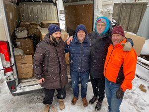 Local men Marc Laine, second left, and Nick Jenkins, right, who drove across Europe to deliver aid to Ukrainian people, with Pasha Peker, left, and Yuriy Ganul.