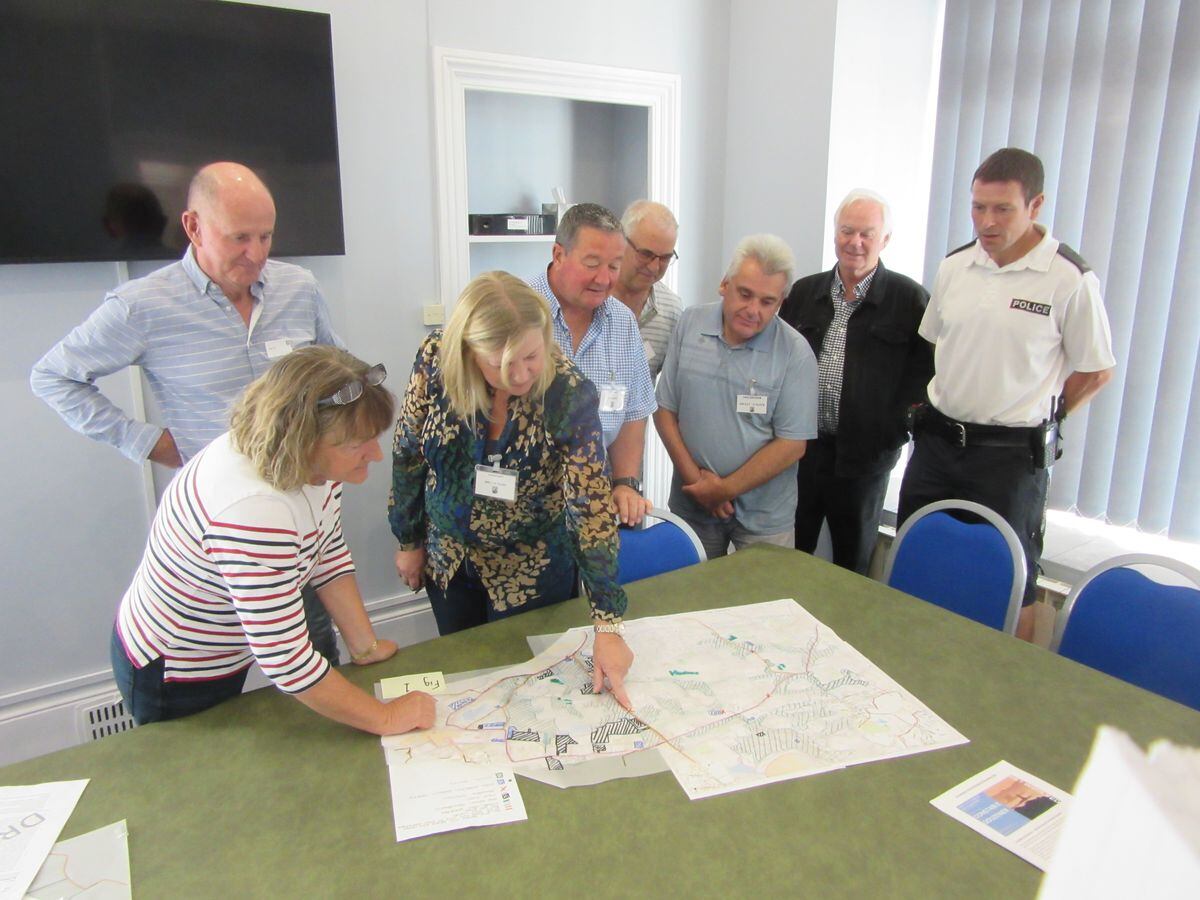 St Sampson's parish officials used a map of roads and developments in the parish in their talks with parishioners about future plans for Parc Le Lacheur. Left to right, Rob Gill, Julie Creed, junior constable Leonie Le Tissier, Andy Carre, Joe Abbotts, Brad Le Flock, senior constable Paul Le Pelley and PC Nicholas Boughay. (31300608)