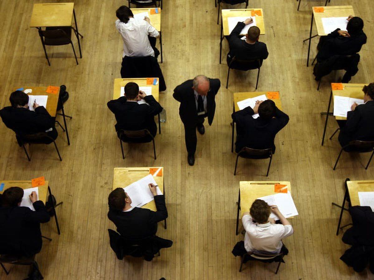 )File picture of UK pupils sitting an exam by David Jones/PA)