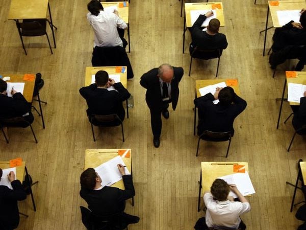 )File picture of UK pupils sitting an exam by David Jones/PA)
