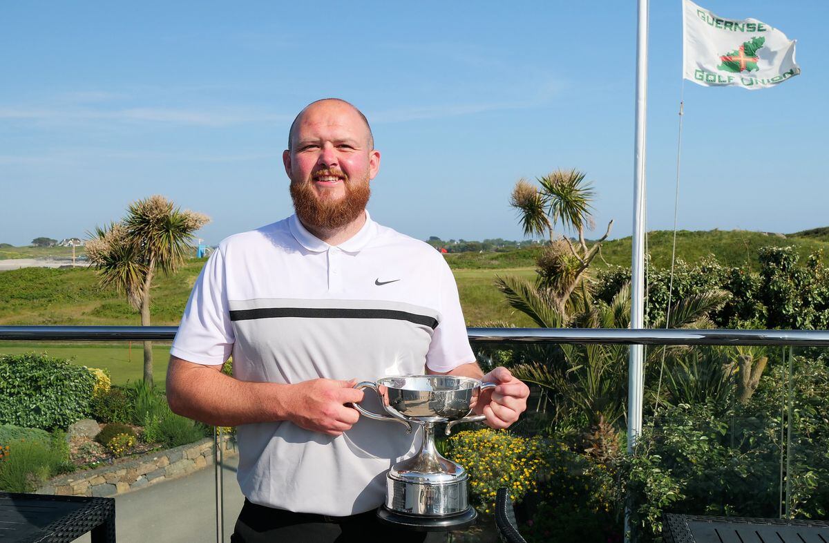 Tom Le Huray lifts the Bachmann Trophy for the second time as Island men's golf champion. (Picture by Gareth Le Prevost, 32160553)