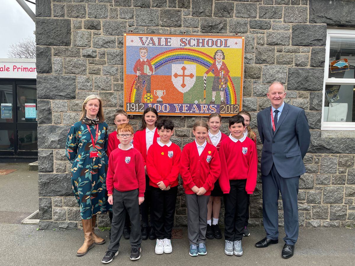 Head teacher Gary Hind and deputy head Lauren Eyton-Jones with some of the Vale Primary pupils whose school was marked as good in all five categories in the first Ofsted inspection tailored for Guernsey.