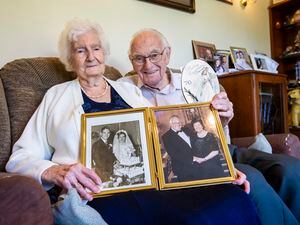 Picture by Luke Le Prevost. 15-09-23..Vie (90, left) and Roy Trustum (92) are celebrating their 70th wedding anniversary. They are holding pictures from their wedding day (left) and their golden anniversary and a congratulations cards.. (32533388)