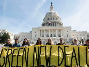 Demonstrators hold a banner on the west front of the Capitol during the Climate Strike protest in Washington. (AP Photo/Kevin Wolf, 25843627)