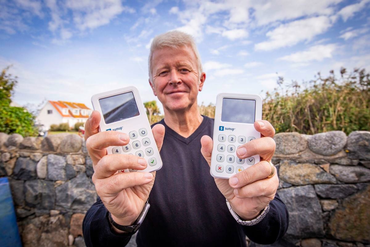 Association of Guernsey Charities vice-president Peter Rose with two of the SumUp contactless card machines, which it loans free of charge to members to make collections. (Picture by Sophie Rabey, 30079070)