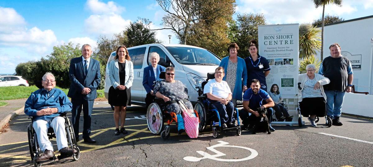 The new Ron Short minibus named in honour of former manager Richard Salisbury will be used to take people who are normally housebound to the shops. Pictured left to right are: Michael Trebert, Paul Guilmoto, Tanya Dorrity, centre chairwoman Pam Bartlett, Sam Le Huray, Lee Vaudin, Mr Salisbury's wife Marilyn, his daughter Helen Sensi, son-in-law Adam Sensi with Sammy the dog, Jean Le Page and Anthony Pengelley. (19387701)