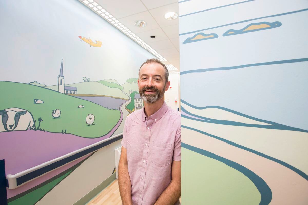Artist James Colmer with some of his work in the corridor to Roustel dementia ward. He has tried to bring inside the feel of the Guernsey outdoors. (Pictures by Adrian Miller, 25463399)