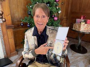 Sir Cliff Richard checks out chart competition as he poses with Stormzy album