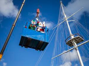 Father Christmas and his elf helper are taken to the top in a crane bucket. (Picture by Luke Le Prevost, 31490102)