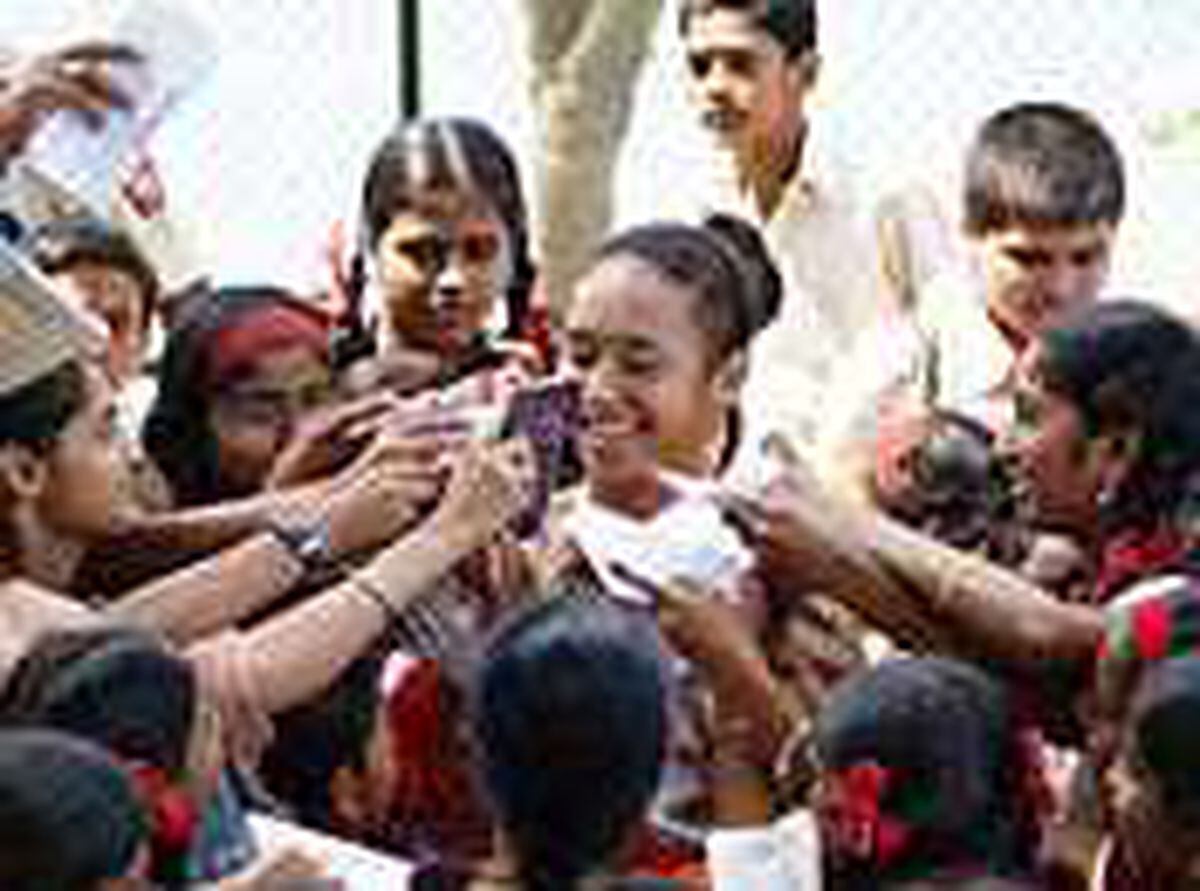 Heather Watson is mobbed by autogragh hunters after having won tennis gold at the Commonwealth Youth Games. 	(Picture by Paul Guillou, 0657507)