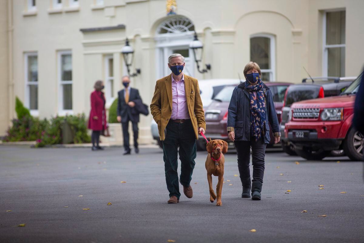 Lt-Governor Sir Ian Corder and Lady Corder walk out of Government House with their dog Milo for the final time. (Pictures by Peter Frankland, 30238461)