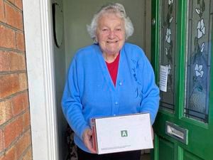 Pauline Leadbeater recieves a parcel last year (please credit St John Guernsey) (29499631)