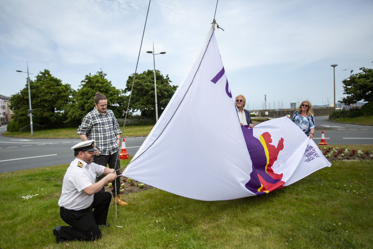 The Platinum Jubilee Flag for Guernsey, designed by competition winner Ben Le Marchant, was hoisted on the Weighbridge roundabout, with Sea Cadets commanding officer Lt Tony Browning lending his expertise. (Pictures by Luke Le Prevost, 30847504)