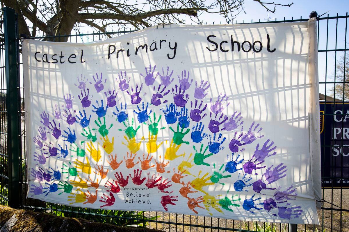A rainbow of hand prints at Castel Primary School. (27900378)