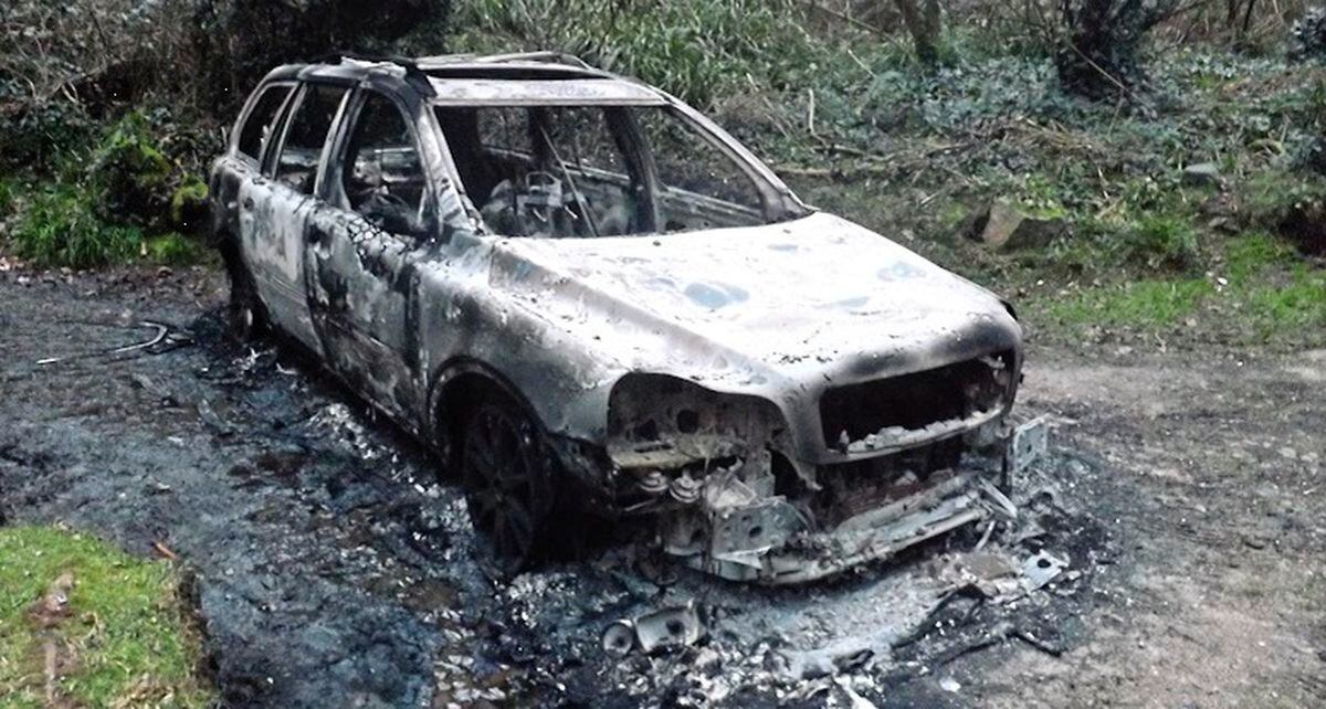The vehicle, possibly a Volvo, which was found burnt out near Petit Bot. Police forensic officers have found what could be skeletal remains in the driver's seat (Picture courtesy Guernsey Police)