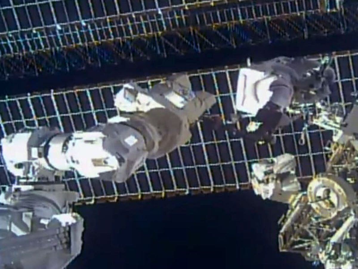 Spacewalking astronauts avoid debris as they repair antenna