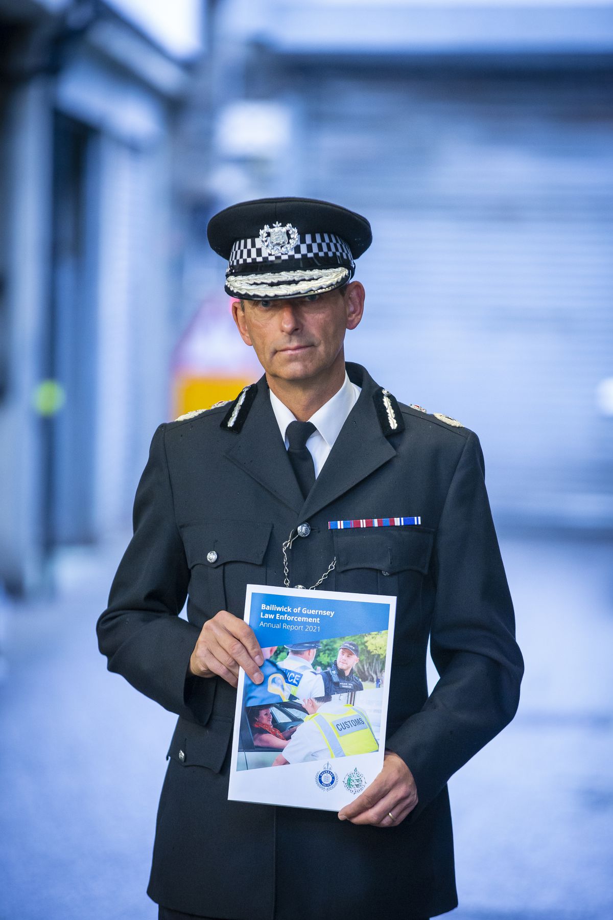 Ruari Hardy, head of Bailiwick Law Enforcement, holding a copy of his annual report for 2021. (Picture by Peter Frankland, 31318765)