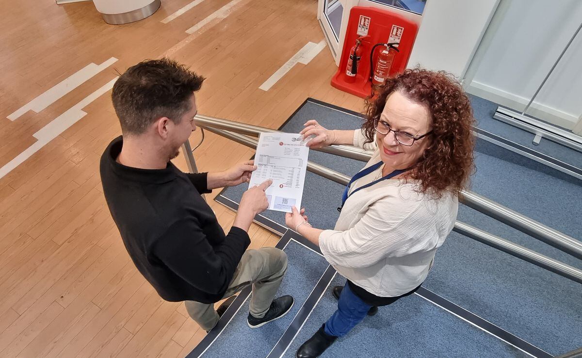 Guernsey Electricity’s head of customer experience Steven Parks, and customer services support agent Paula Locke, showing the features of the updated statements for customers.