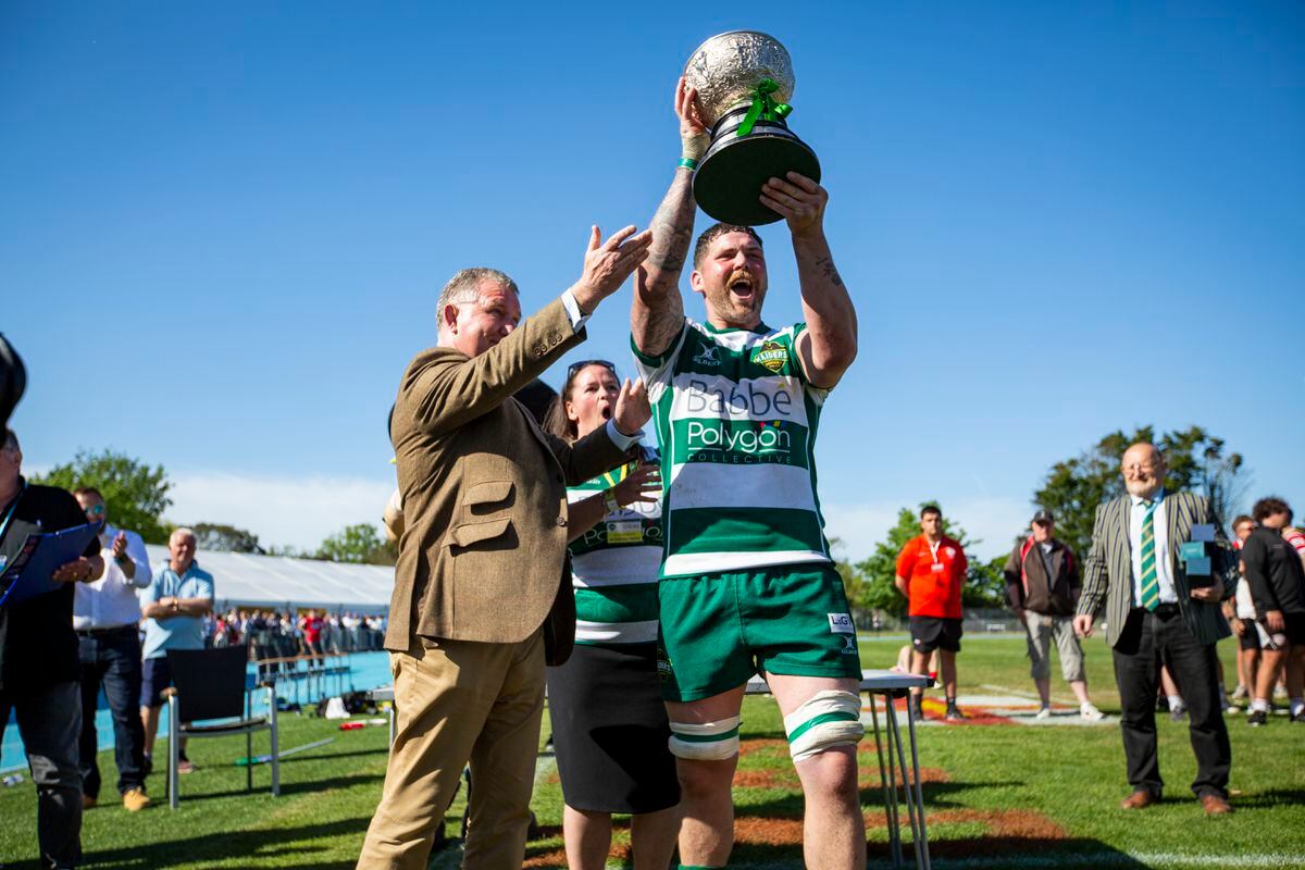 Guernsey Raiders captain Lewis Hillier shows the Siam Cup to the large home crowd after his side had beaten Jersey Reds Athletic for the second week in a row in the Spring Insure-sponsored match. (Pictures by Luke Le Prevost,  30846326)