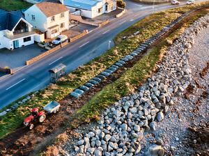Picture By Peter Frankland. 15-12-21 Environment Guernsey Limited are doing some work on the coastal path at Route Des Pecqueries. The company is part of Societe Guernesiaise. Peter Bourgaize driving his tractor, which has been used to pile up gravel on the path.. (30335052)