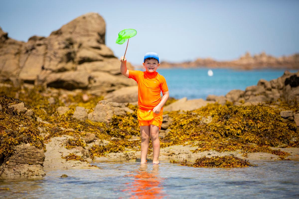 Eoghan McCarthy, 6, rock pooling at Cobo during one of the days in July when the temperature topped 30C.  (Picture by Luke Le Prevost, 31906599)